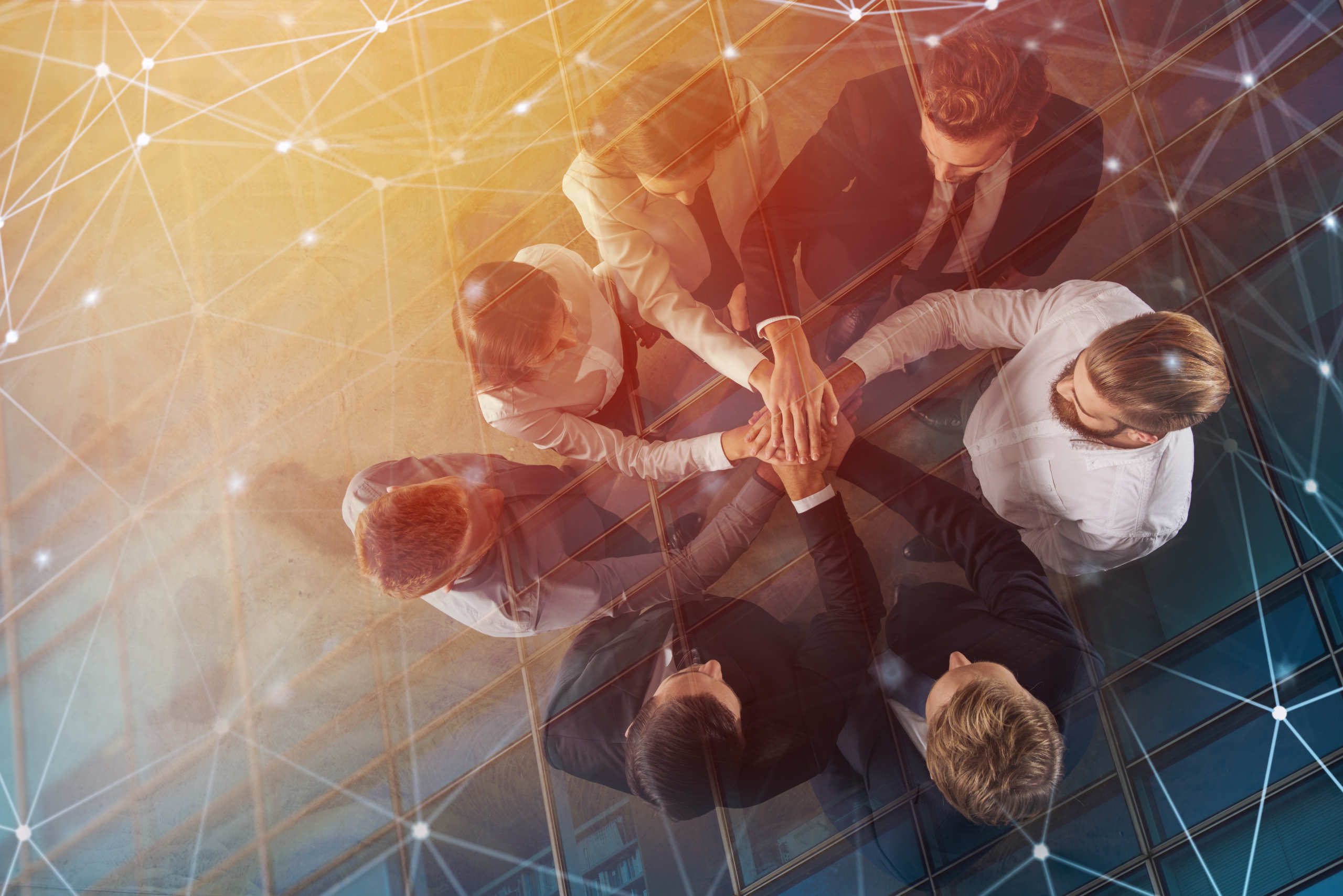 Business people putting their hands together with internet network effects. Concept of integration, teamwork and partnership. double exposure