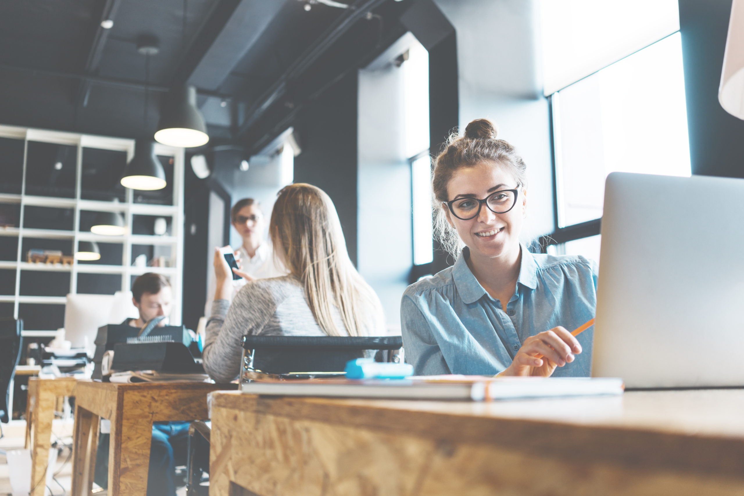 Portrait of young handsome business lady working at her desk wit